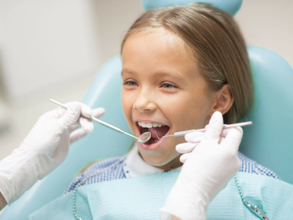 image of a girl in a dental chair getting her teeth checked