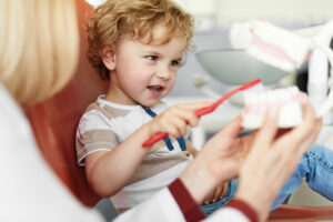 image of a little boy practicing brushing his teeth