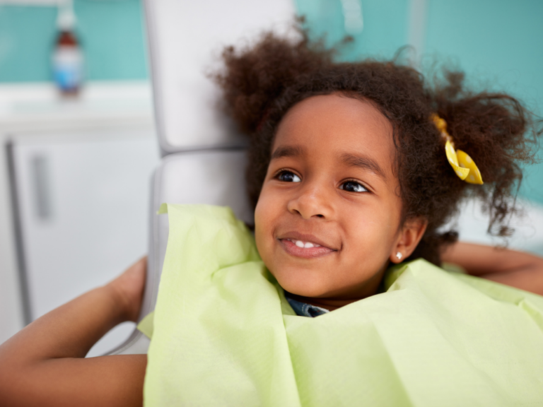 image of little girl smiling in dental chair