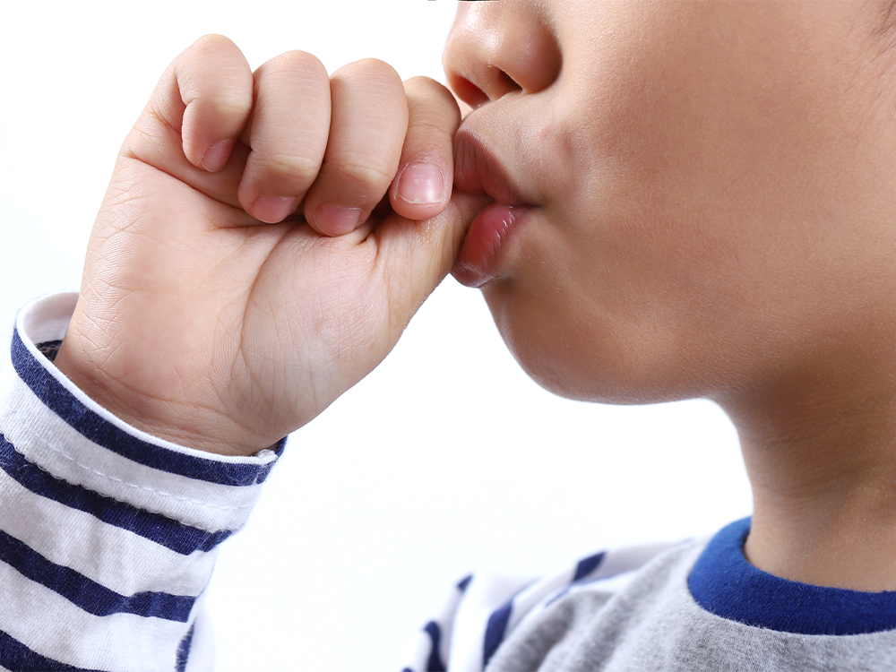 image of a boy sucking his thumb