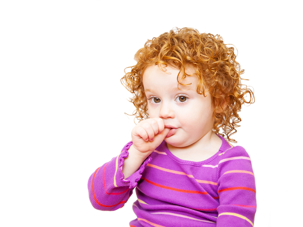 image of a little girl sucking her thumb
