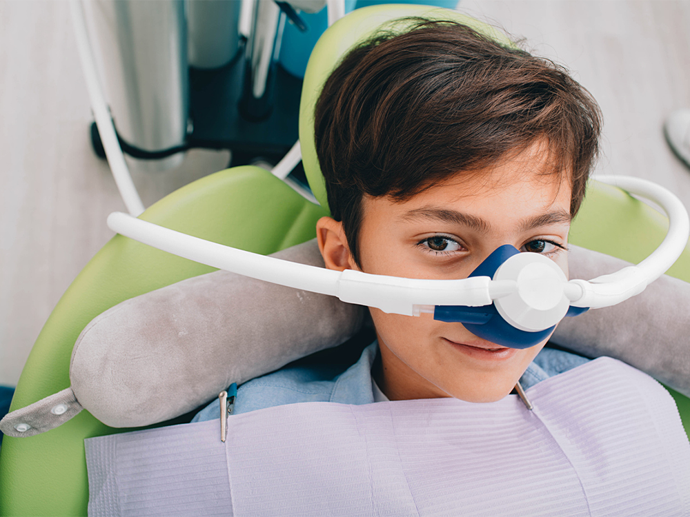 image of a boy receiving laughing gas
