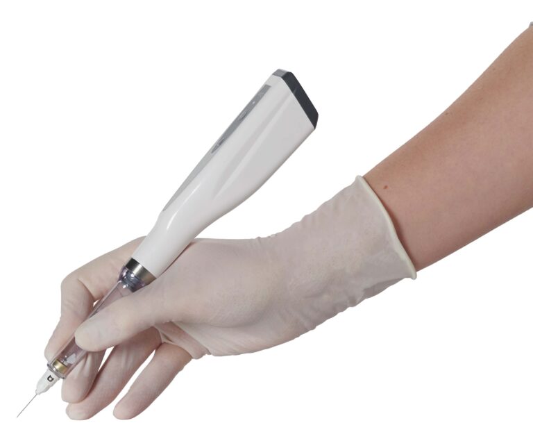 A hand in a white latex glove holds a white medical injection pen with a black tip and visible needle, poised for use. The sterile instrument and gloved hand suggest a clinical procedure, emphasizing safety and precision in healthcare settings.
